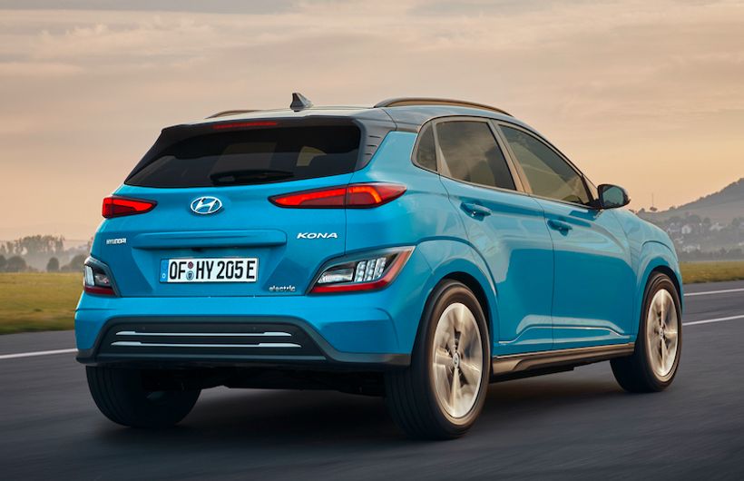Hyundai Kona Electric car exterior rear driving in country